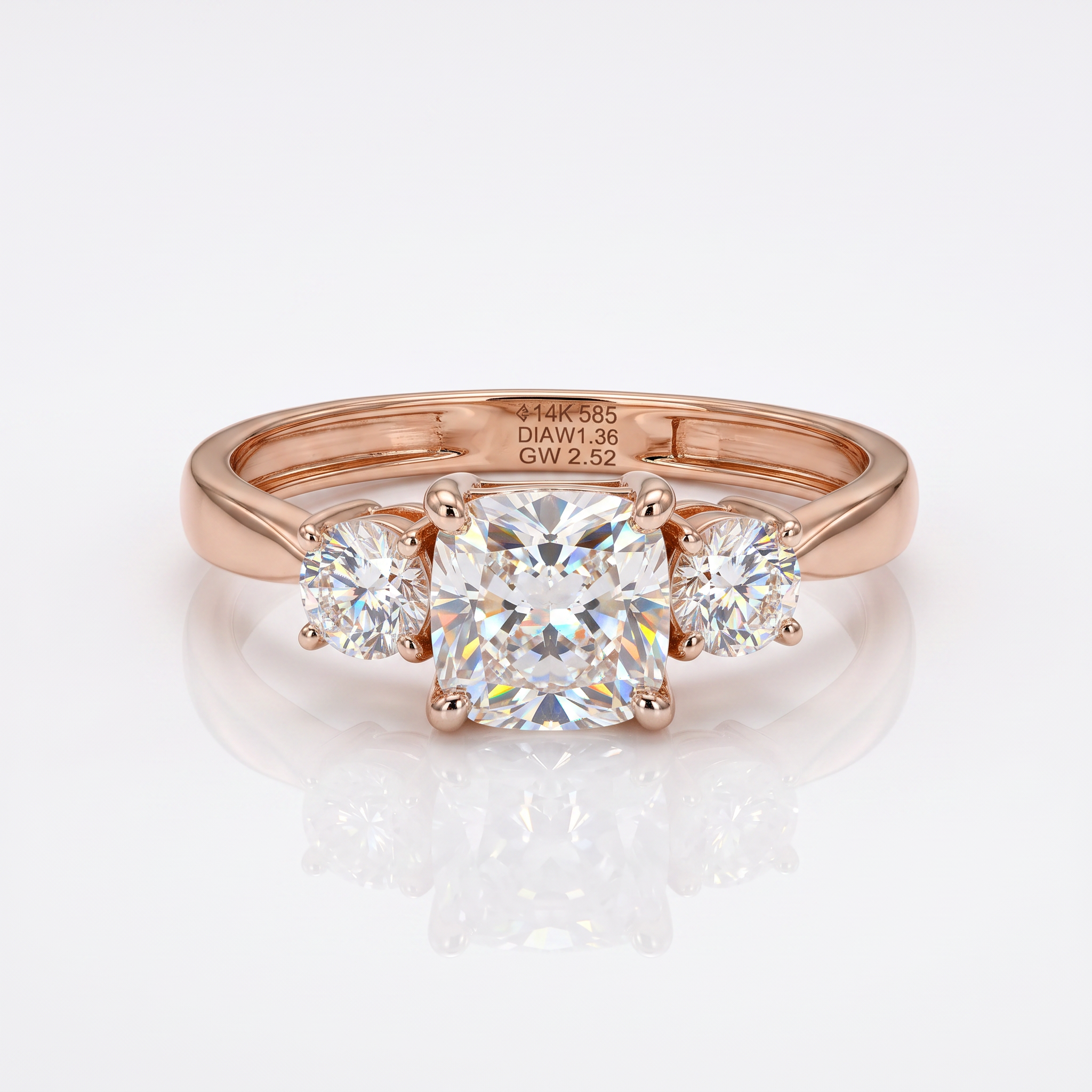 A rose gold three-stone engagement ring with a central cushion-cut diamond and two round side diamonds, displayed on a clean white reflective surface.