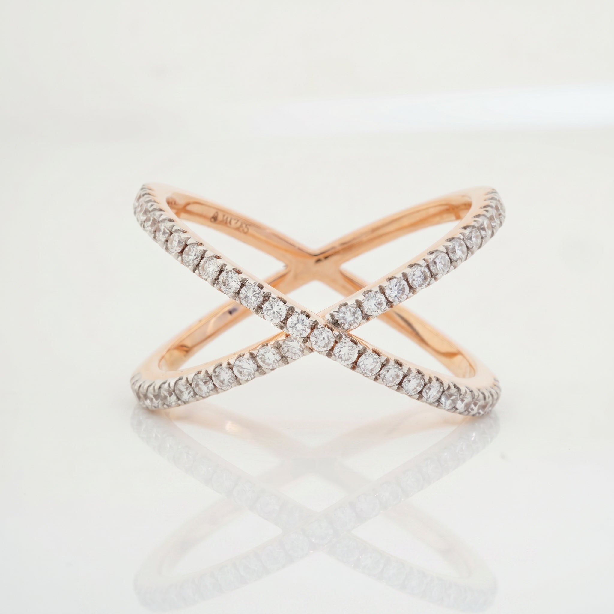 Round brilliant diamond infinity crossover ring with criss-cross pavé bands in rose gold by Glora Diamonds Chennai