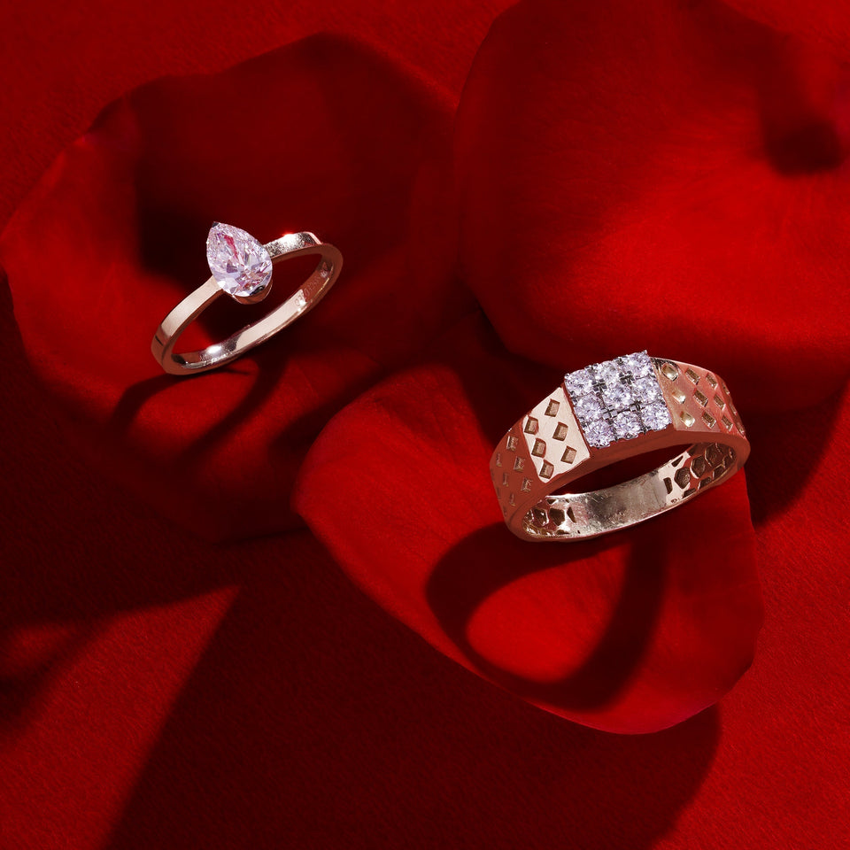 Two decorative rings arranged on red fabric