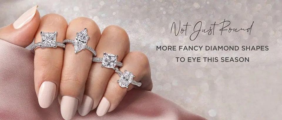 A hand wearing rings with different centre-stone shapes