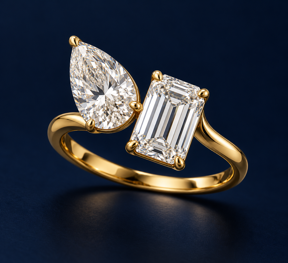 A pear-shaped and rectangular two-stone ring on a navy background