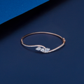 Rose gold bracelet with diamonds on a blue background