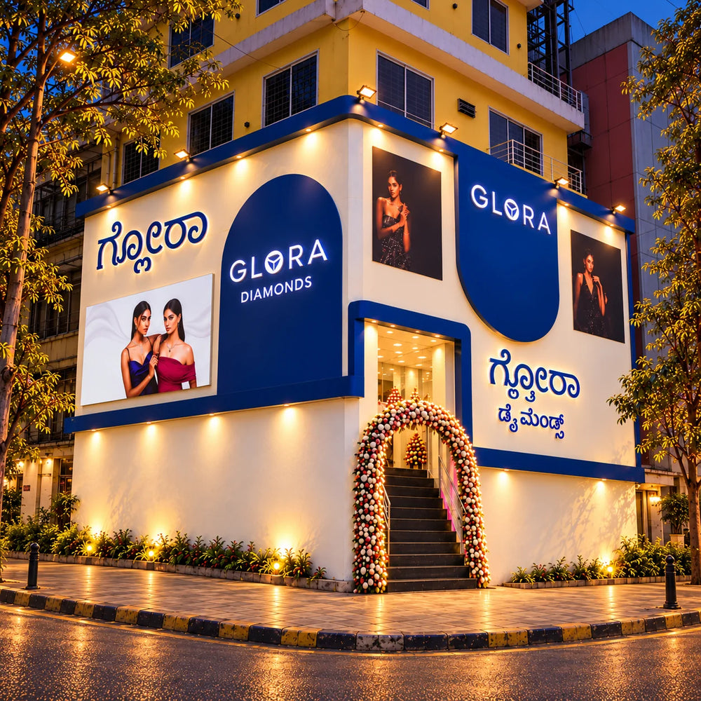 Square evening exterior render of Glora Diamonds showroom on Dickenson Road, Bengaluru, showing the illuminated blue facade and entrance steps