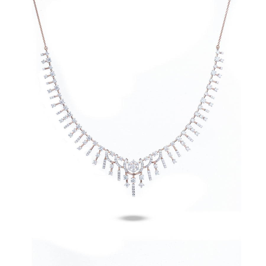 A delicate necklace with a V-shaped arrangement of small clear stones in a rose gold setting, suspended from a fine rose gold chain, shown against a plain white background.