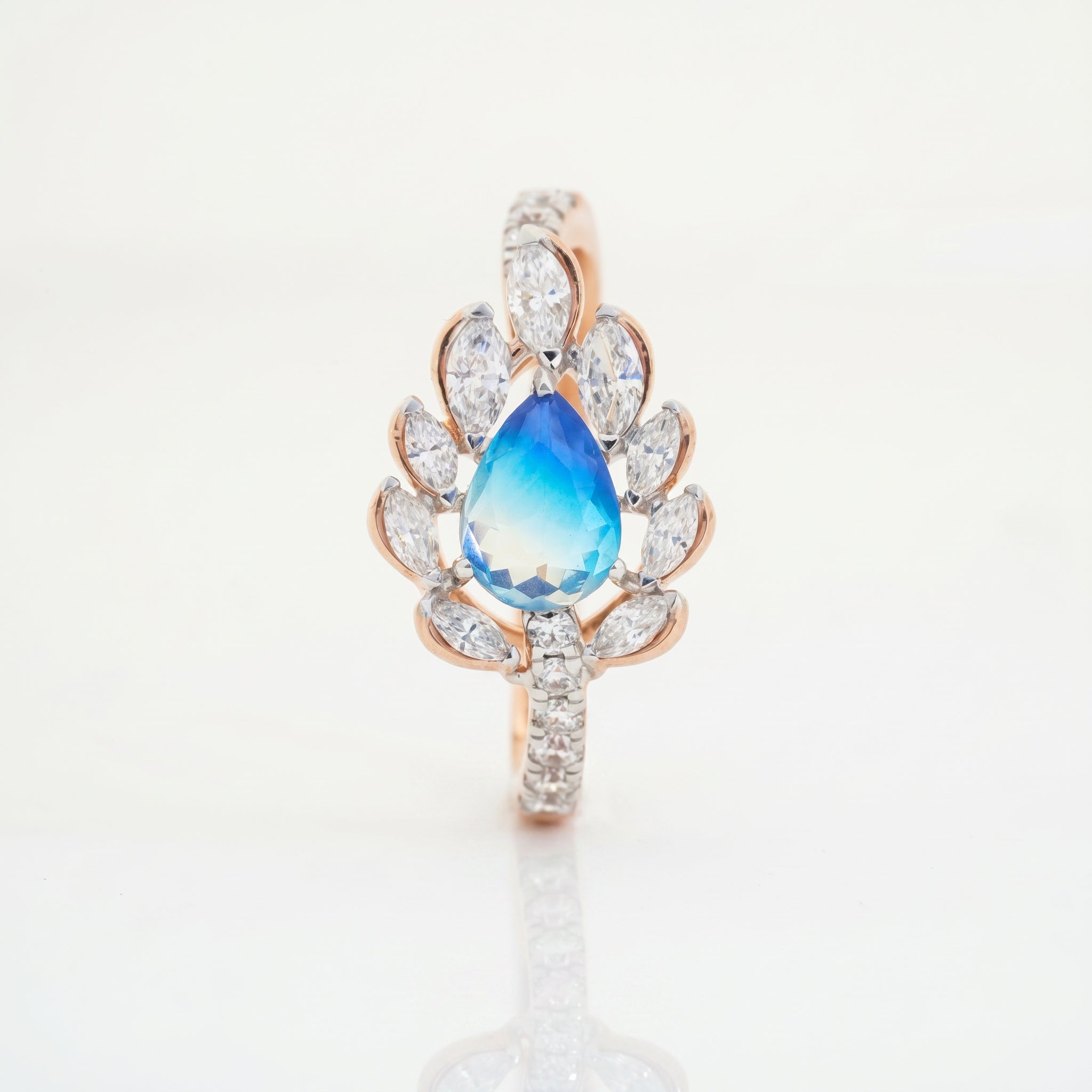 Pear cut blue gemstone bloom ring with marquise diamonds and pavé diamond band in rose gold by Glora Diamonds Chennai