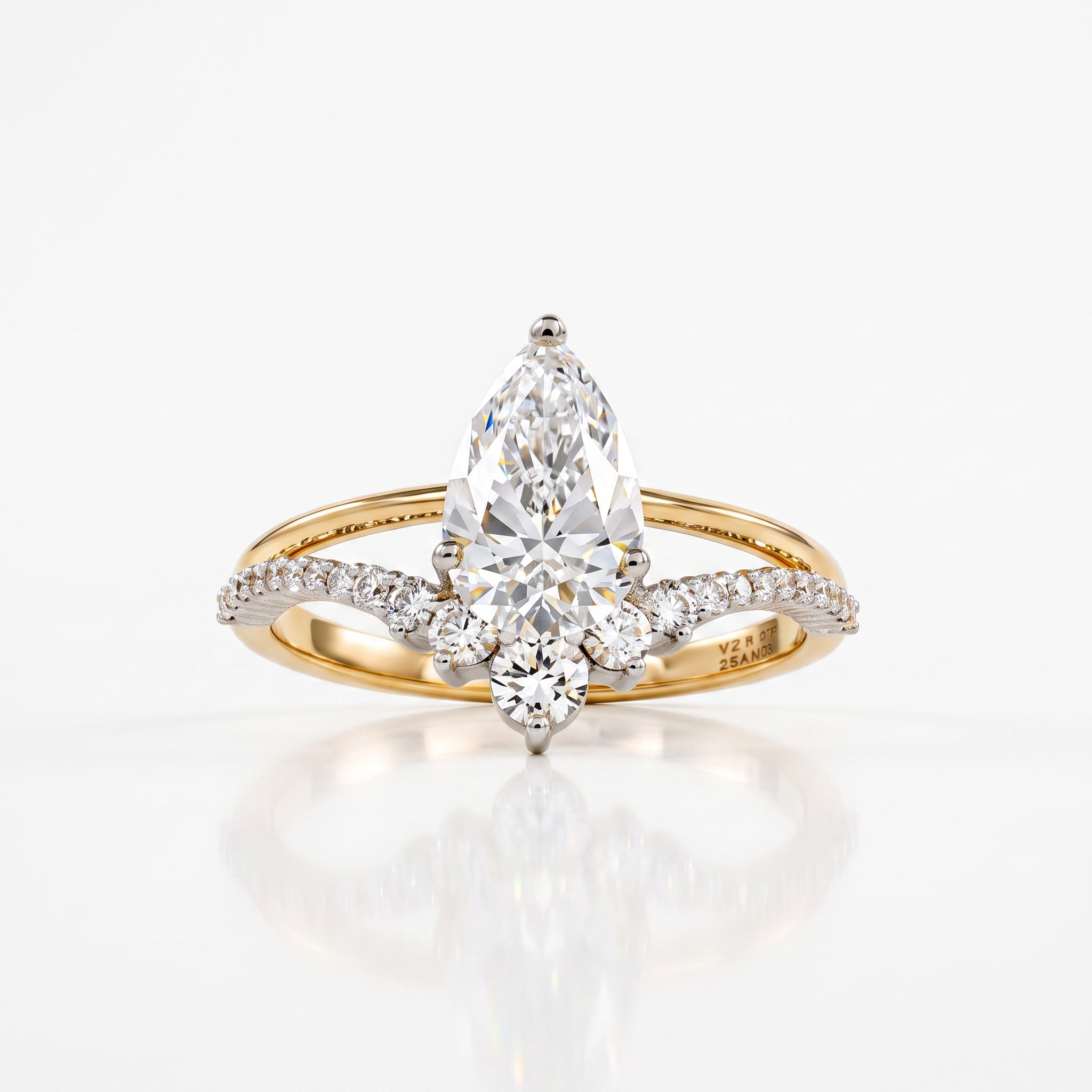 A yellow gold ring featuring a large pear-cut diamond center stone with smaller diamonds along the shoulders, set against a clean white background with a soft reflection.