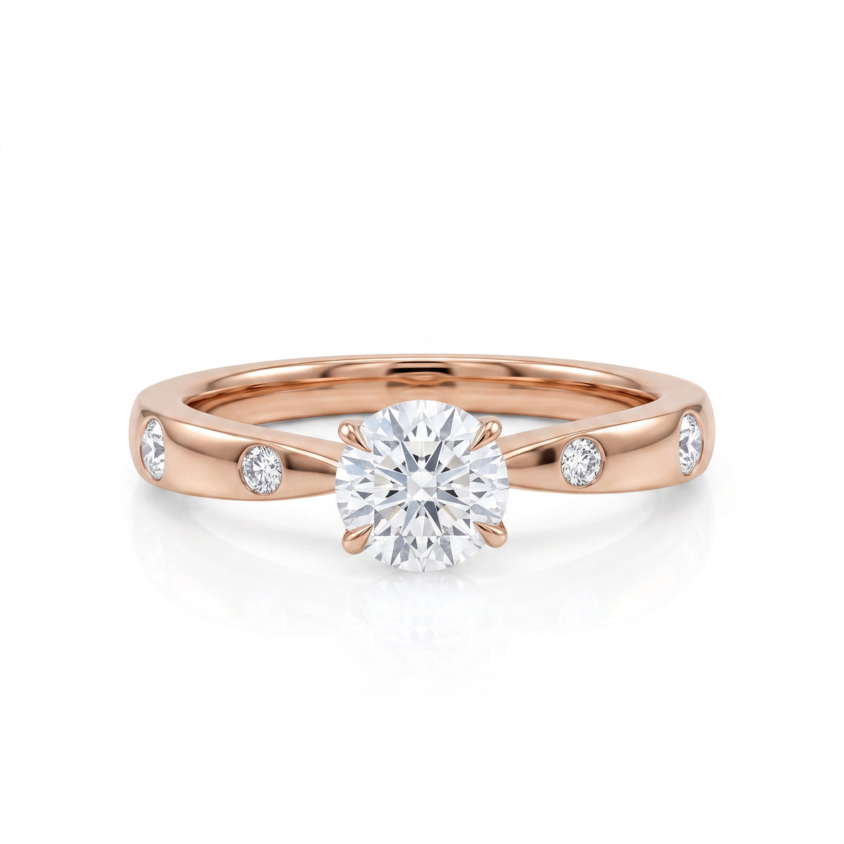 A rose gold solitaire engagement ring with a round-cut diamond center stone and three small round diamonds set along the band, shown on a clean white background.