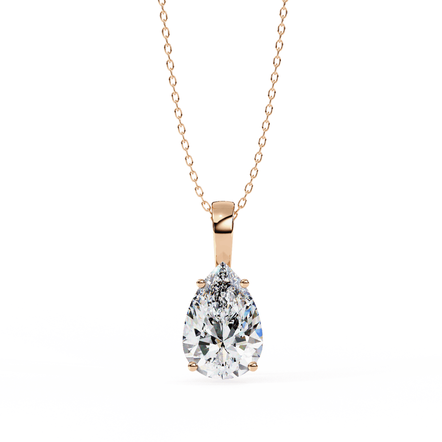 A diamond pendant with a gold chain, featuring a single, large, clear diamond centerpiece.