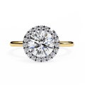 A round diamond ring with smaller diamonds around it, set in a gold band.