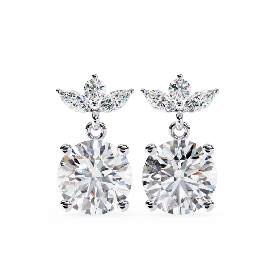 A pair of diamond earrings with intricate metalwork, set against a white background.