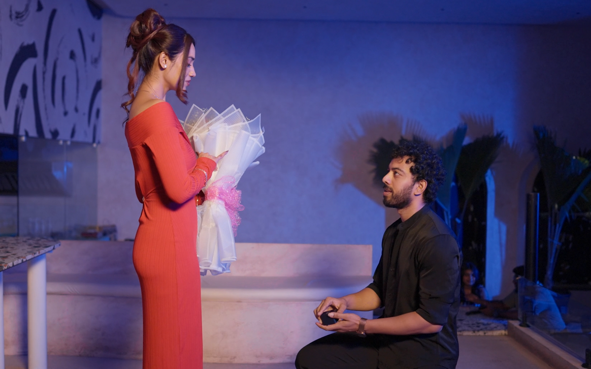 Couple in a proposal scene with a ring