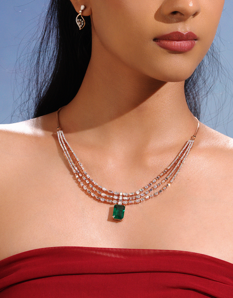 Model wearing layered diamond necklaces